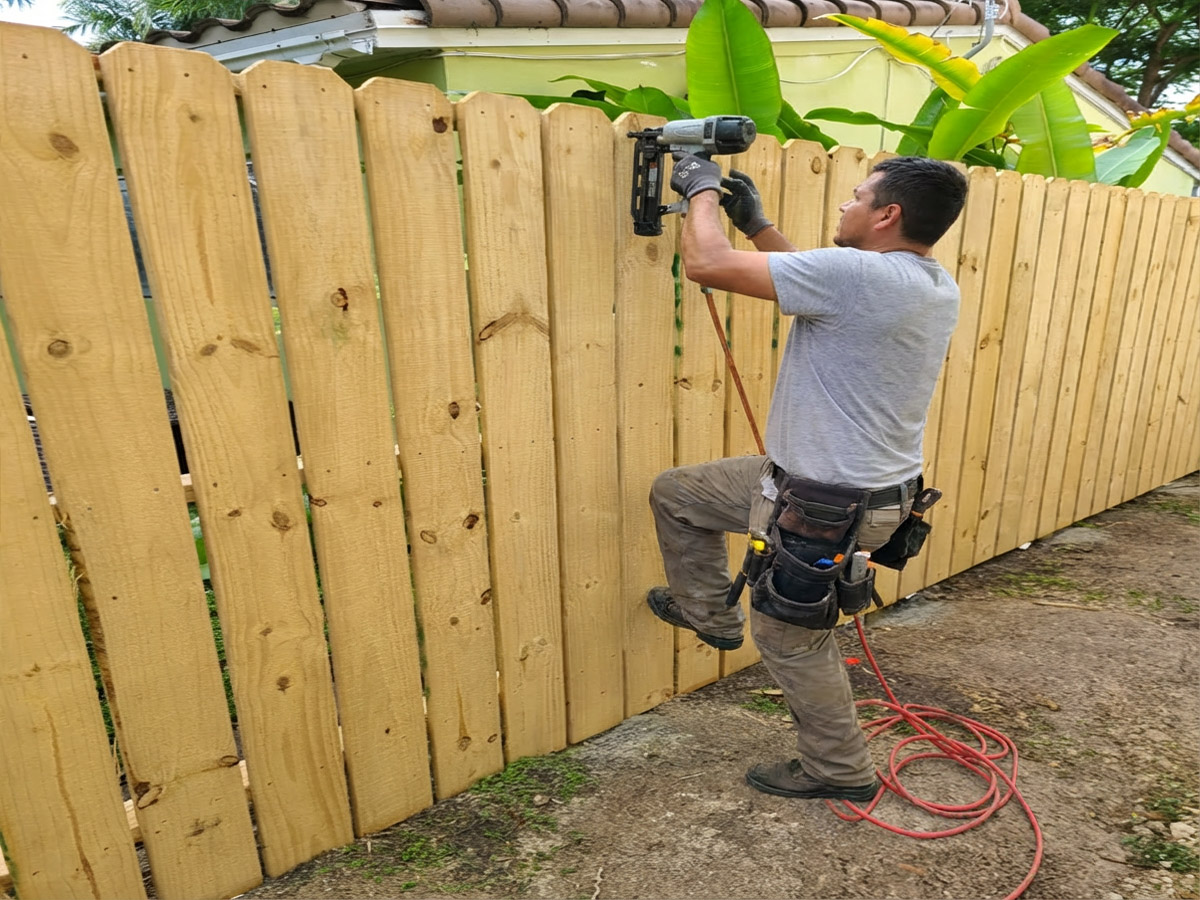 Wood Fence Contractor Wood Fence Contractor at work in Broward County, Florida