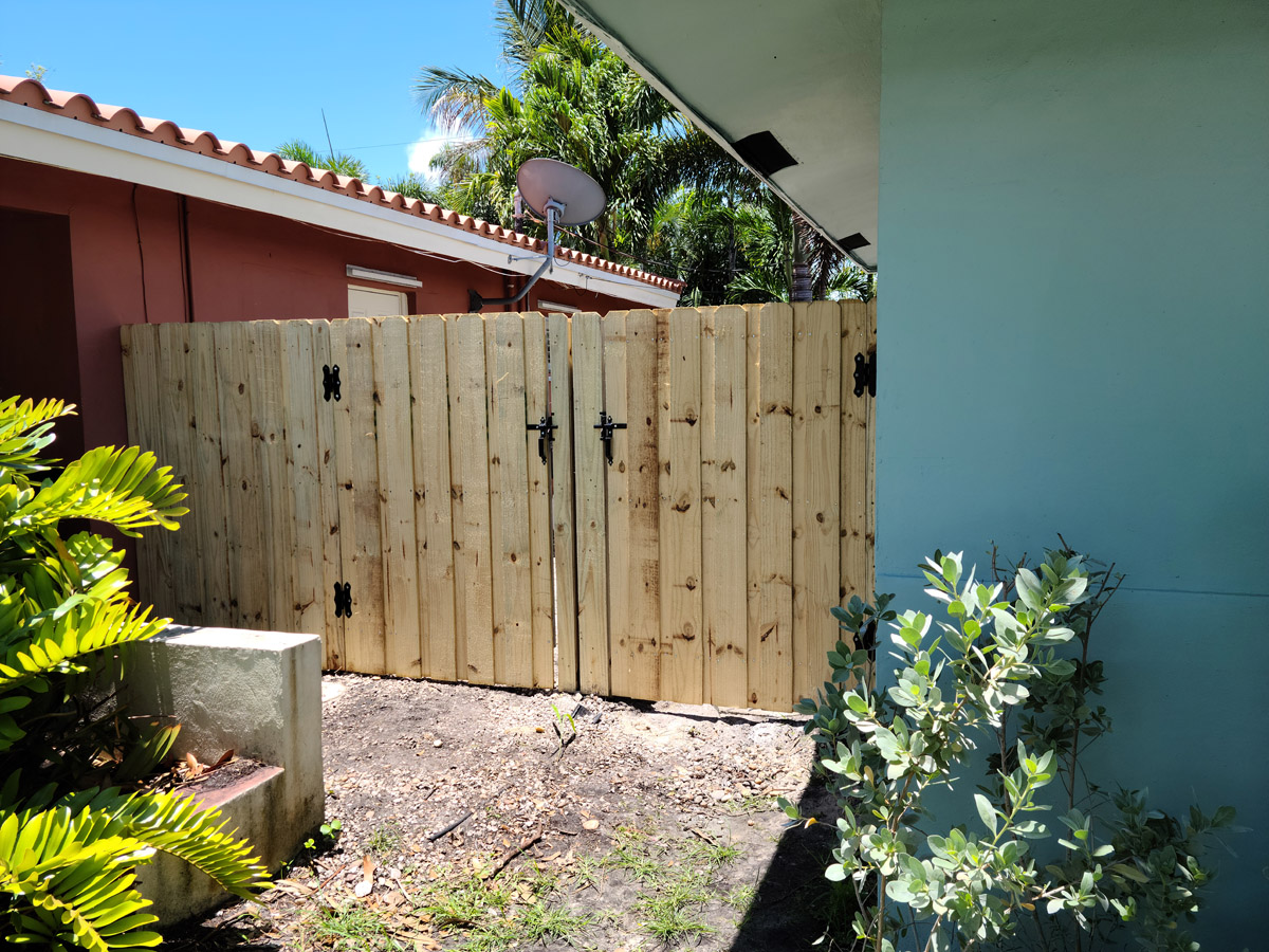 Wood fence construction job Wooden gate and wall installation
